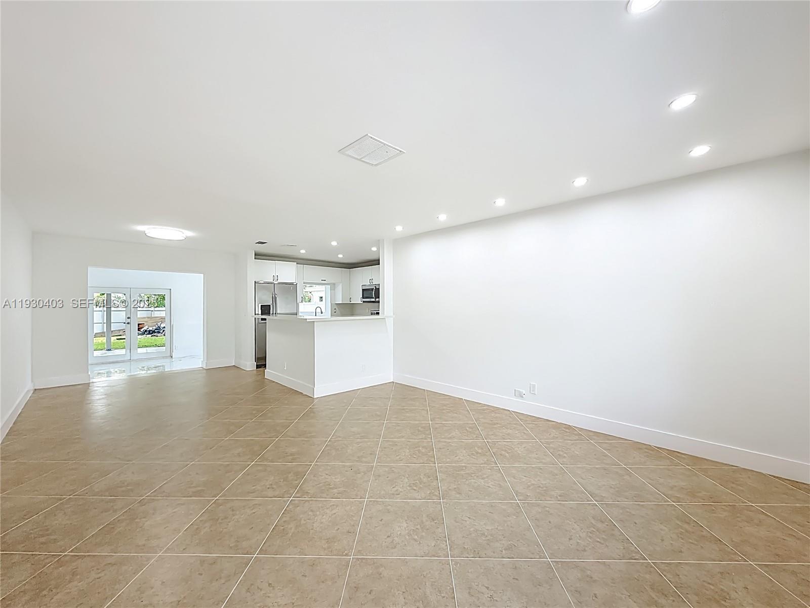 4008 Adams Street Hollywood, FL 33021 - Photo 7 of 54 a view of empty room with kitchen and window
