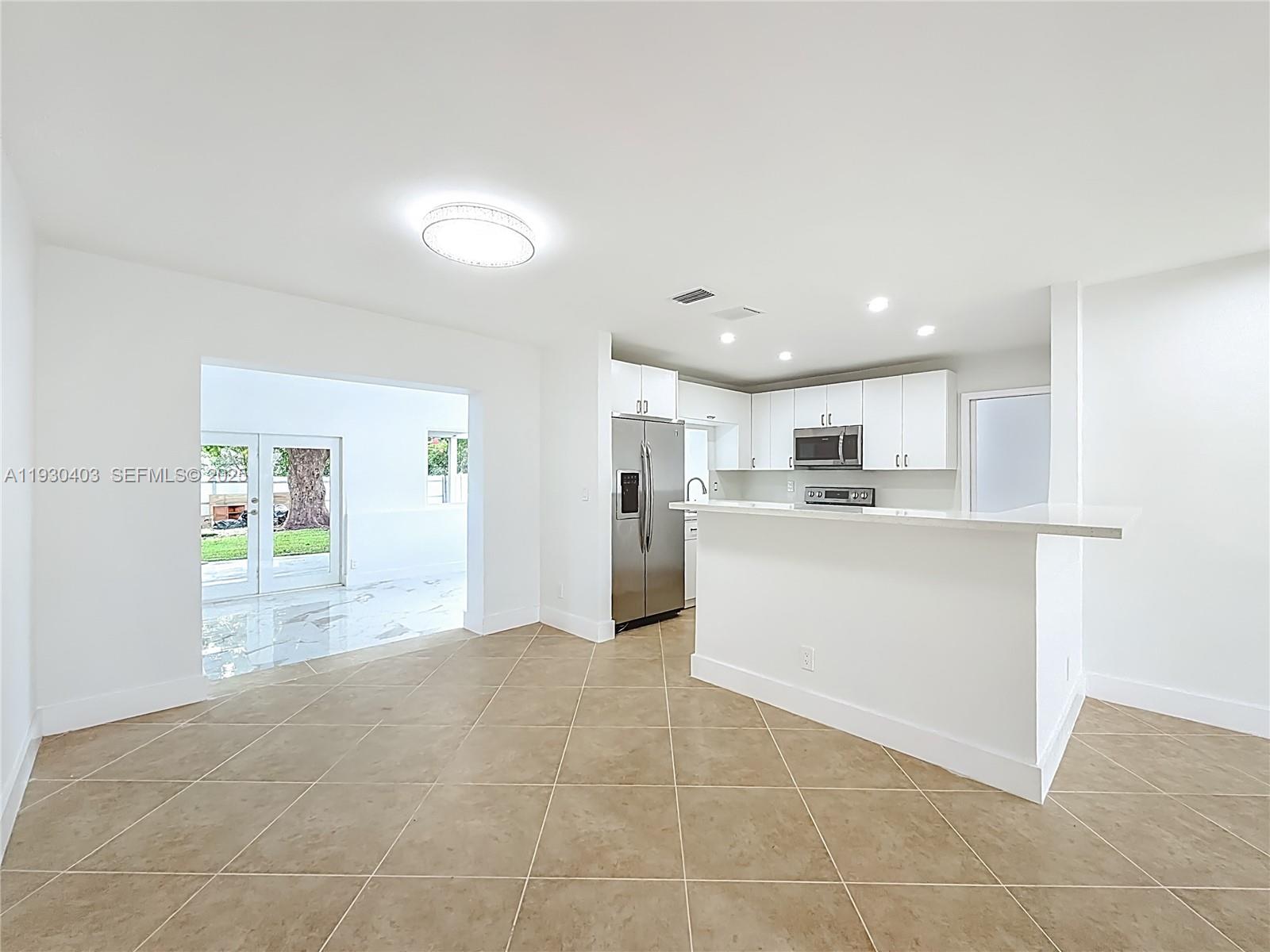 4008 Adams Street Hollywood, FL 33021 - Photo 10 of 54 a view of a kitchen with kitchen island and stainless steel appliances