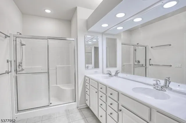 a bathroom with double vanity sink and a mirror