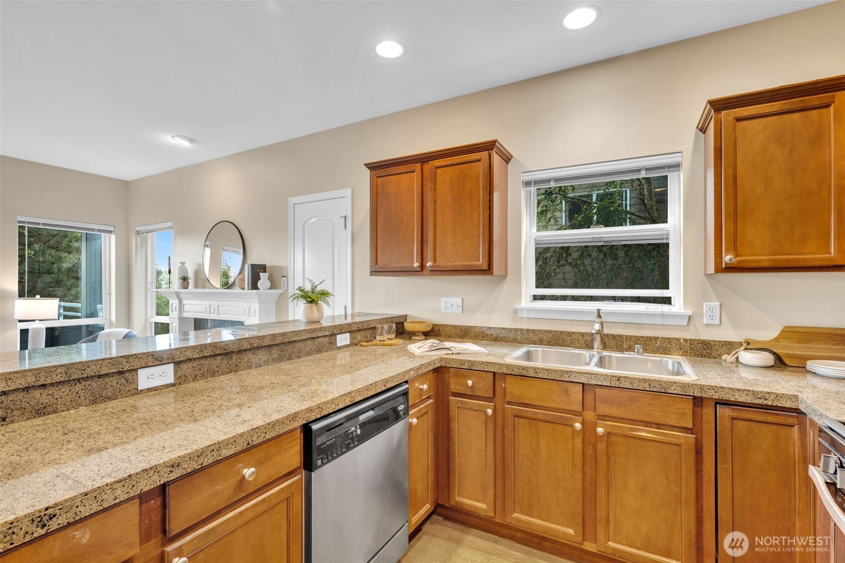 3112 Southwest Avalon Way, Unit 302 Seattle, WA 98126 - Photo 10 of 40 a kitchen with stainless steel appliances granite countertop a sink stove and cabinets