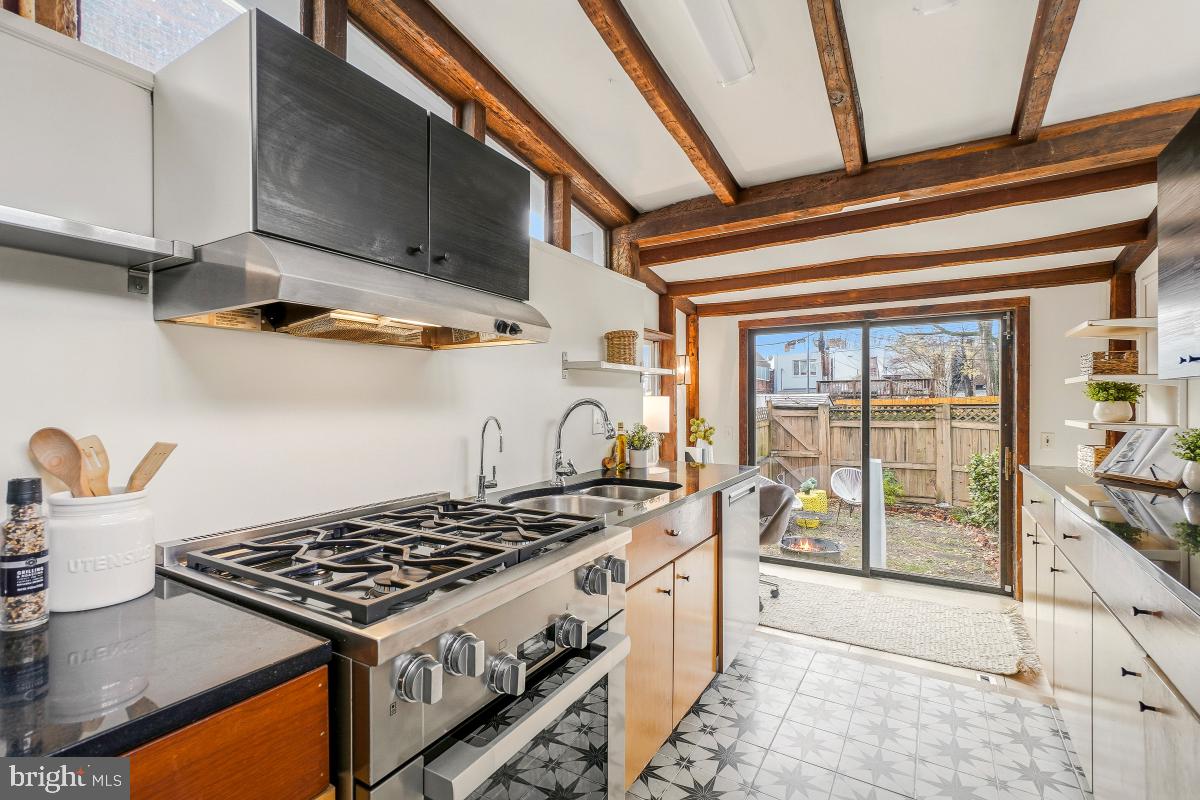 505 9th Street Southeast Washington, DC 20003 - Photo 14 of 30 a kitchen with stainless steel appliances granite countertop a stove a sink and a microwave