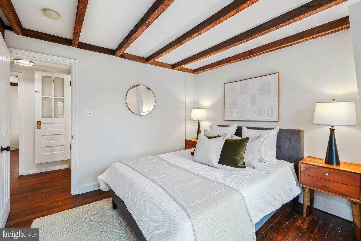 505 9th Street Southeast Washington, DC 20003 - Photo 22 of 30 a bedroom with a bed and wooden floor
