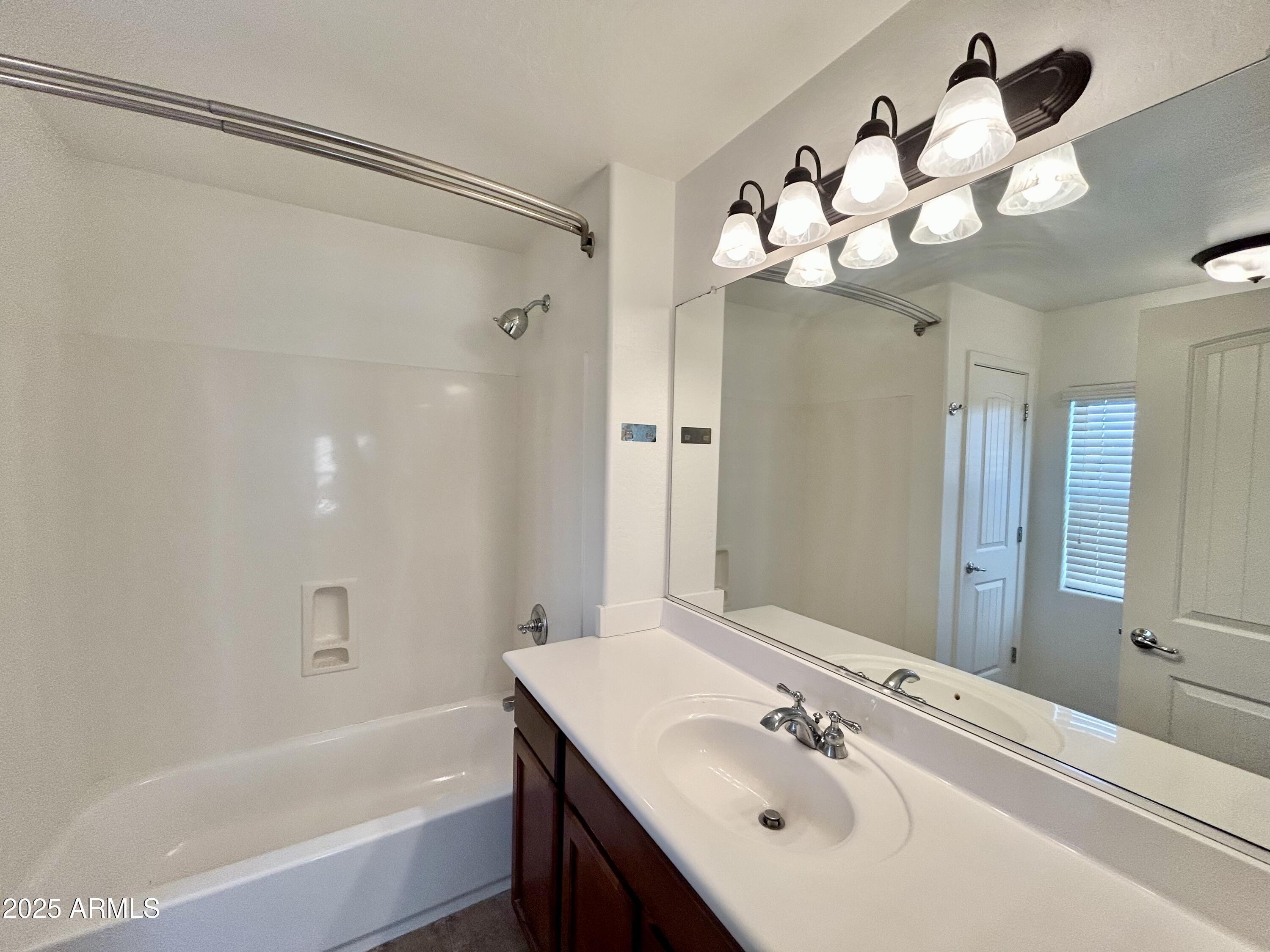 1418 South Jessica Lane Tempe, AZ 85281 - Photo 13 of 13 a bathroom with a sink mirror and a bathtub