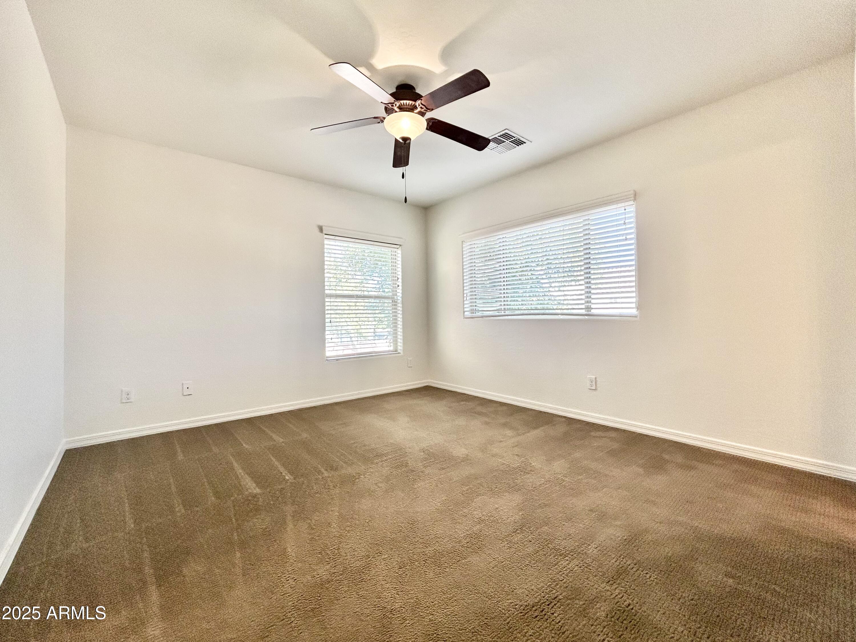 1418 South Jessica Lane Tempe, AZ 85281 - Photo 10 of 13 an empty room with windows and fan