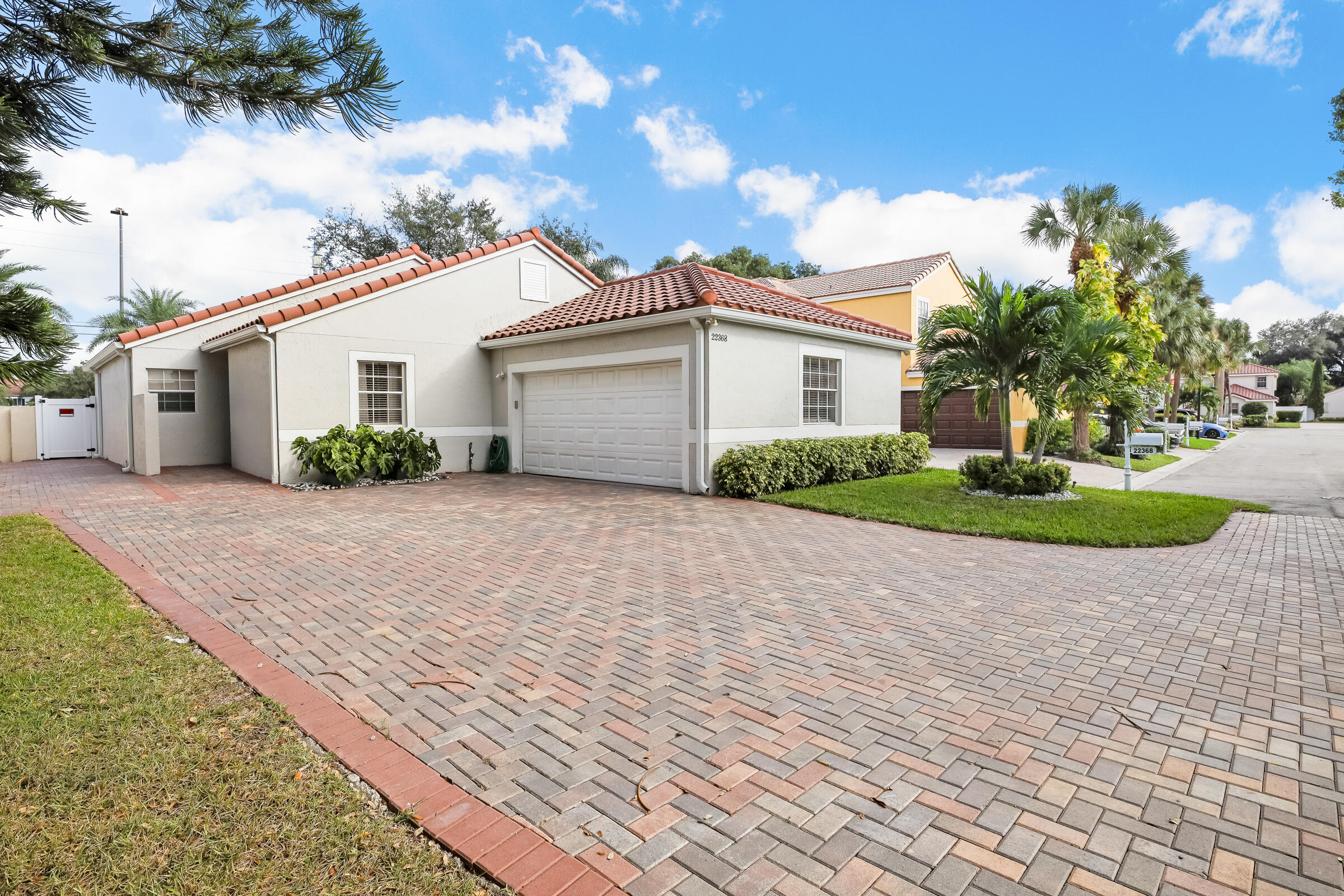 22368 Overture Circle Boca Raton, FL 33428 - Photo 2 of 47 a view of a house with a yard and potted plants