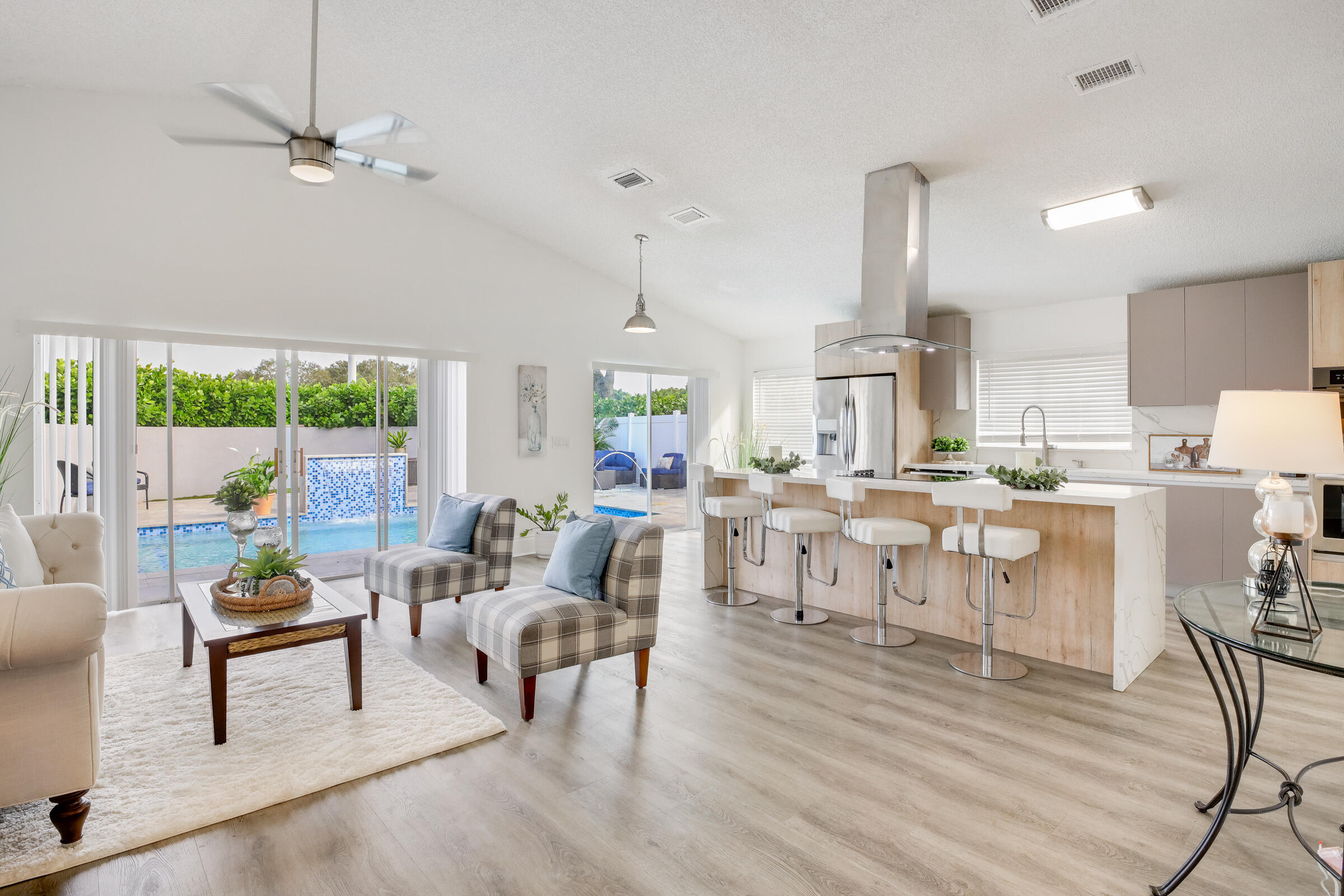 22368 Overture Circle Boca Raton, FL 33428 - Photo 8 of 47 a living room with lots of furniture kitchen view and a wooden floor