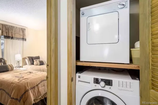 a view of a bedroom with a bed and a mirror