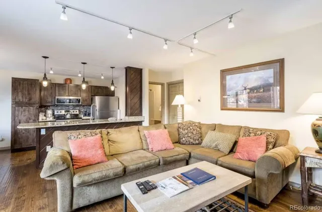a living room with furniture and kitchen view