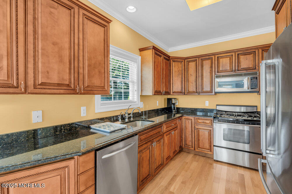 419 Central Avenue Spring Lake, NJ 07762 - Photo 15 of 41 a kitchen with stainless steel appliances granite countertop a stove a sink and a microwave