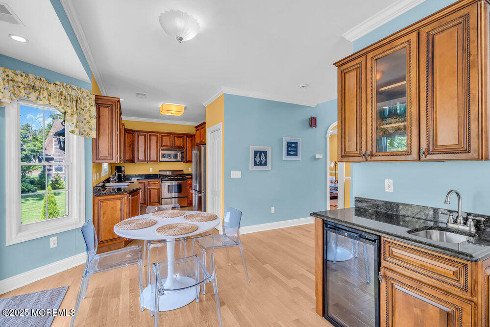 419 Central Avenue Spring Lake, NJ 07762 - Photo 18 of 41 a kitchen with stainless steel appliances granite countertop a sink a stove a dining table and chairs