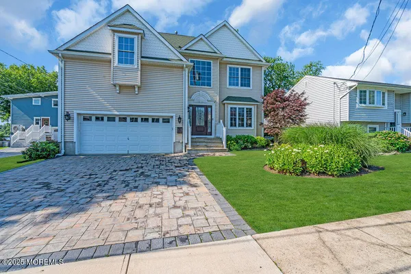 a front view of a house with a garden