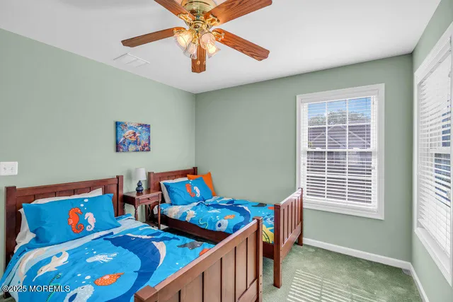 a bedroom with a bed a chair and a chandelier