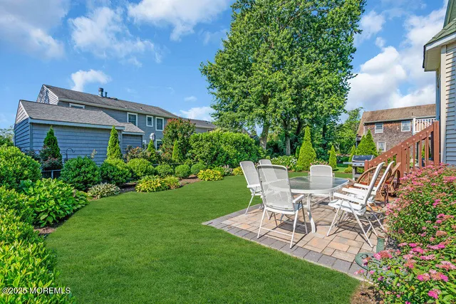 a view of a house with backyard and sitting area