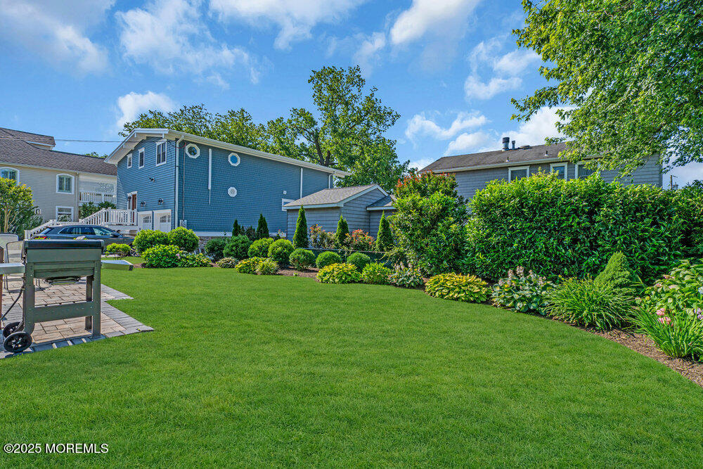 419 Central Avenue Spring Lake, NJ 07762 - Photo 41 of 41 a backyard of a house with table and chairs