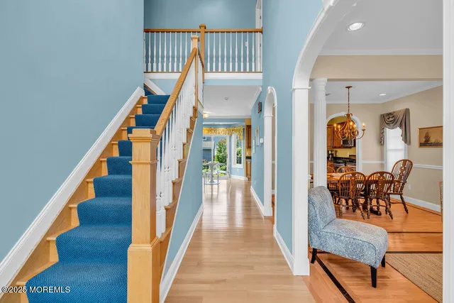 a view of a hallway with furniture and wooden floor