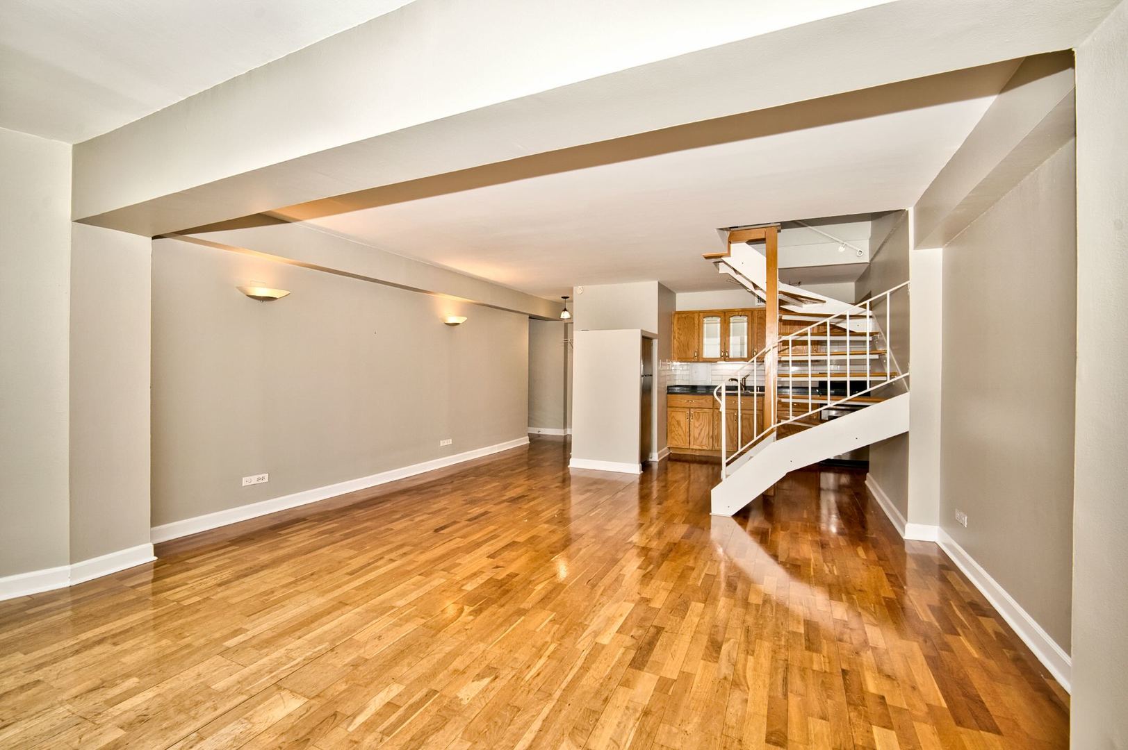 6166 North Sheridan Road, Unit 26A Chicago, IL 60660 - Photo 11 of 27 a view of an empty room with wooden floor and a window
