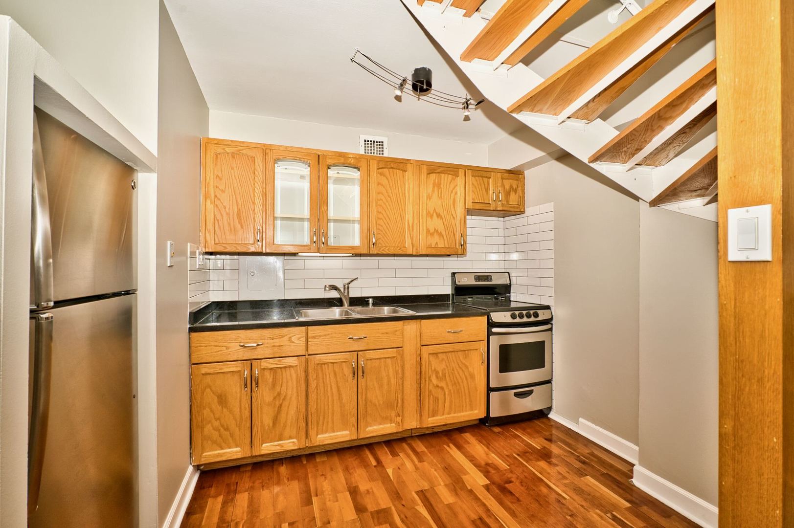 6166 North Sheridan Road, Unit 26A Chicago, IL 60660 - Photo 13 of 27 a kitchen with stainless steel appliances granite countertop a refrigerator a sink and white cabinets
