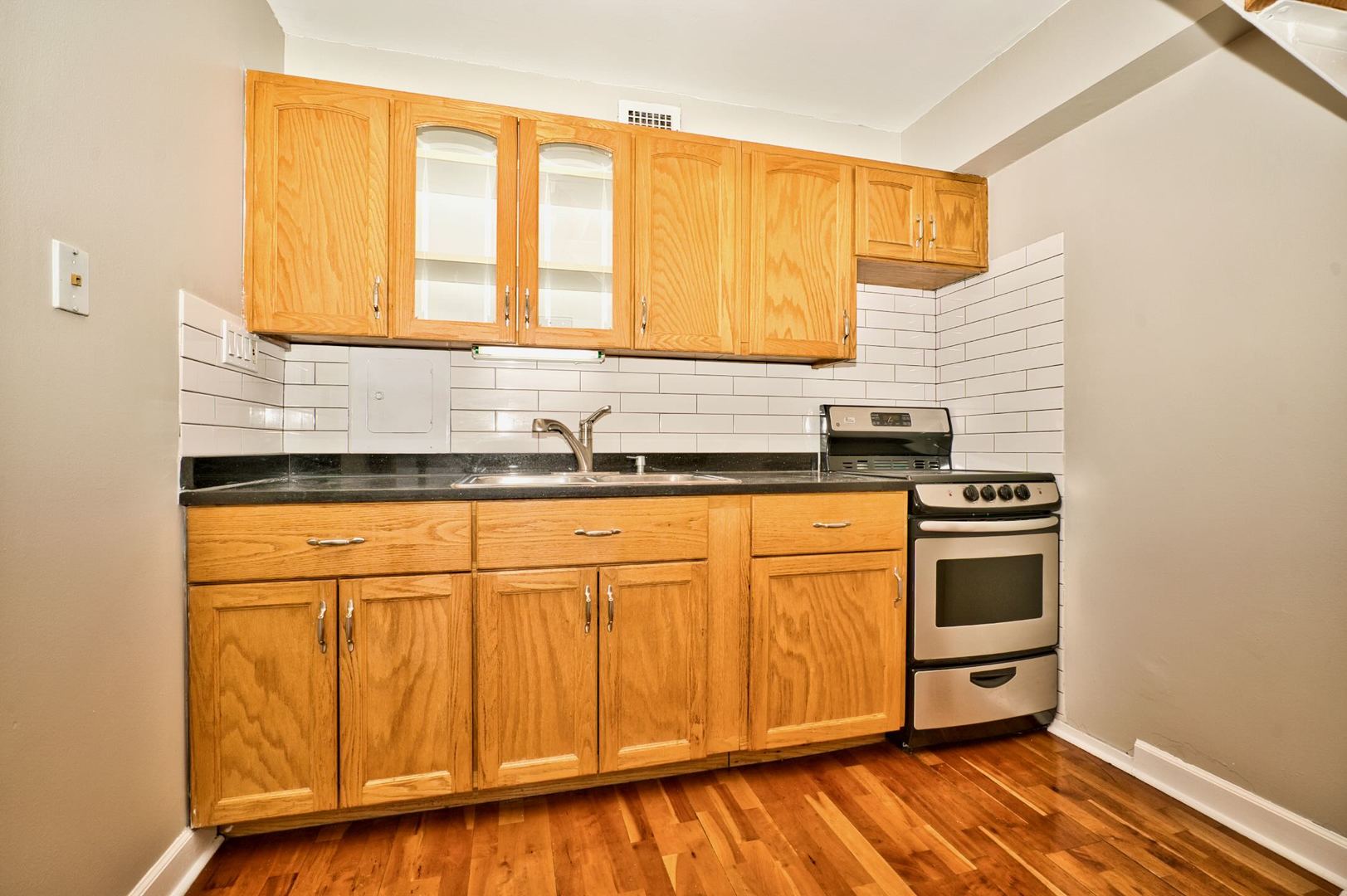 6166 North Sheridan Road, Unit 26A Chicago, IL 60660 - Photo 15 of 27 a kitchen with stainless steel appliances granite countertop a stove a sink and a microwave