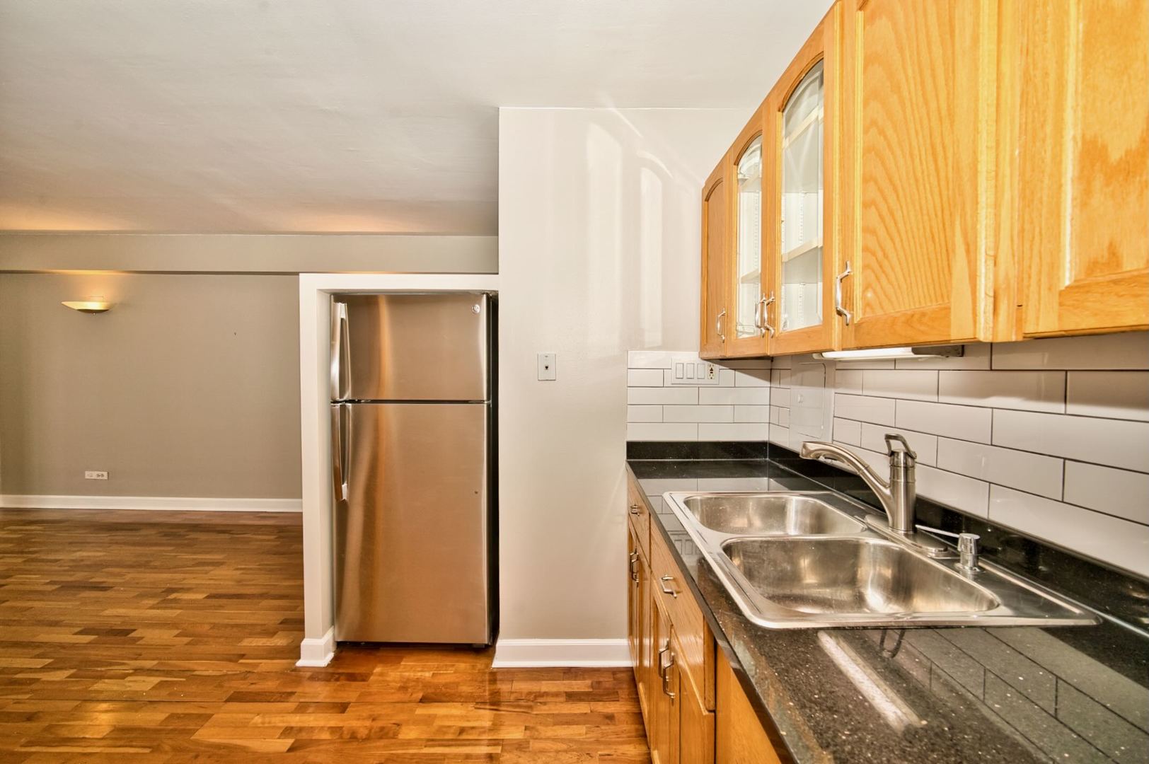 6166 North Sheridan Road, Unit 26A Chicago, IL 60660 - Photo 16 of 27 a kitchen with a sink a refrigerator and window