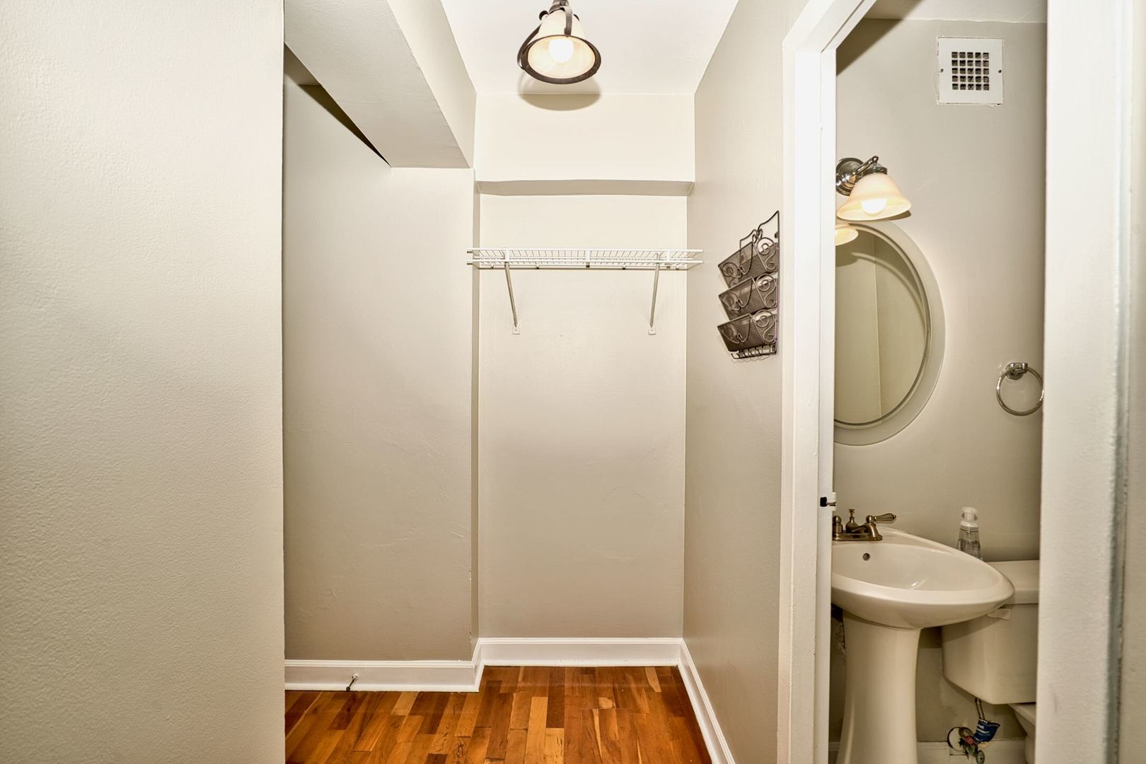 6166 North Sheridan Road, Unit 26A Chicago, IL 60660 - Photo 3 of 27 a bathroom with a sink and mirror
