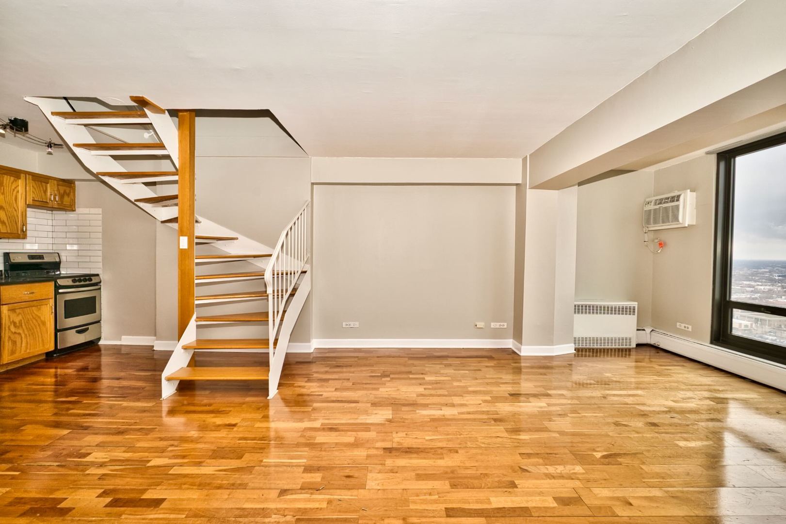 6166 North Sheridan Road, Unit 26A Chicago, IL 60660 - Photo 8 of 27 a view of a room with wooden floor and windows