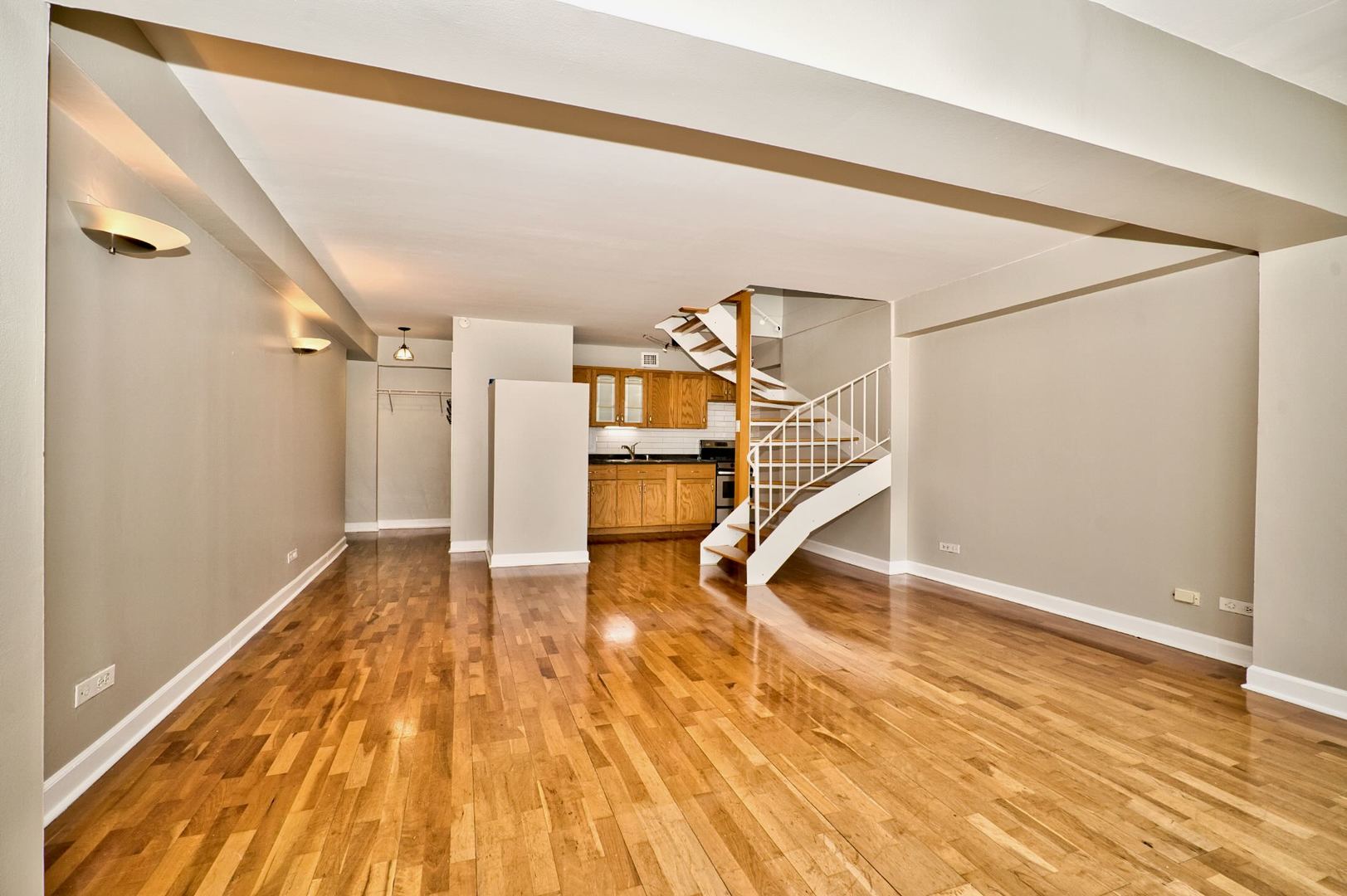 6166 North Sheridan Road, Unit 26A Chicago, IL 60660 - Photo 9 of 27 a view of a room with wooden floor and white walls