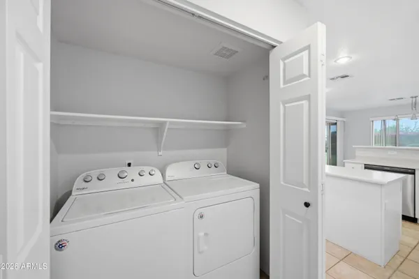 a view of storage and utility room with washer and dryer