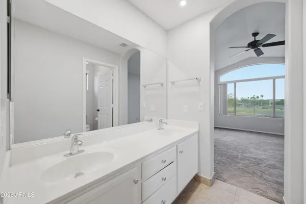 a spacious bathroom with a shower sink and mirror