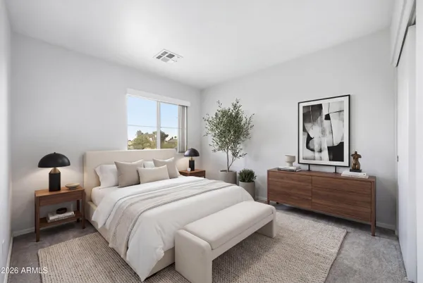 a bedroom with two beds and a chair