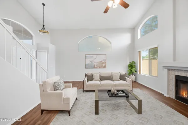 a living room with furniture a chandelier and a fireplace