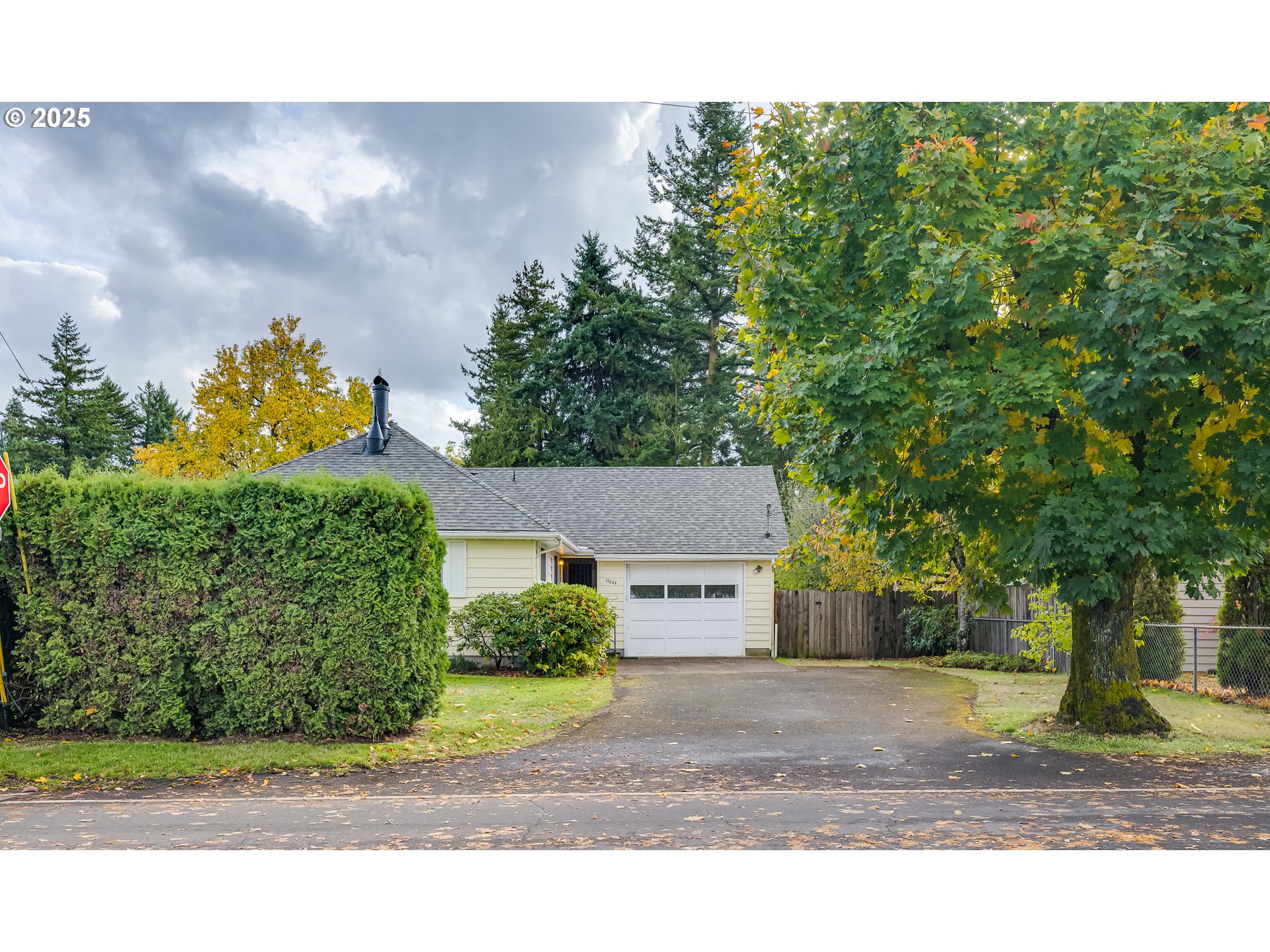 a bird view of a house with a yard and garage