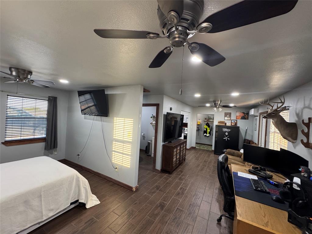 386 County Road 604 Hamilton, TX 76531 - Photo 3 of 20 a view of a workspace with furniture and a ceiling fan