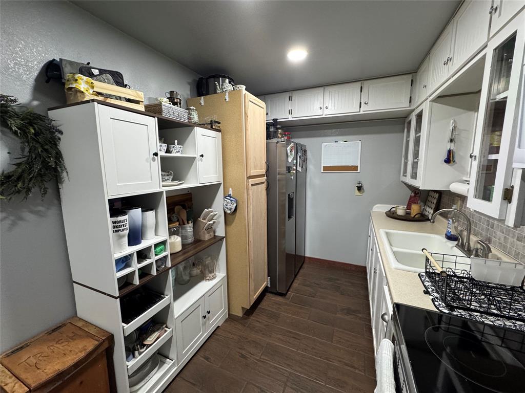 386 County Road 604 Hamilton, TX 76531 - Photo 5 of 20 a kitchen with refrigerator and cabinets