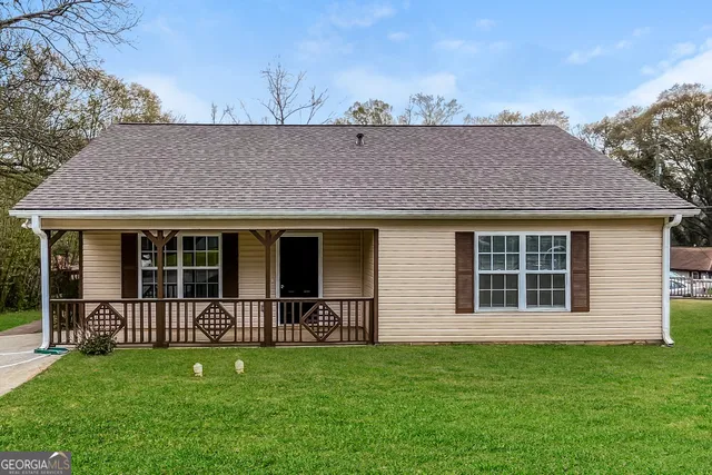 a front view of a house with a garden