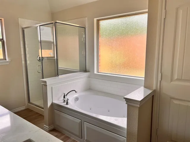 a bathroom with a bathtub and a shower