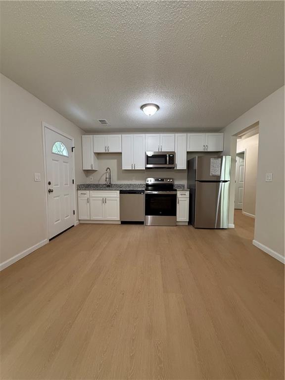 3319 Decatur Street Columbus, GA 31906 - Photo 2 of 18 a large kitchen with a stove top oven a refrigerator and a granite counter top