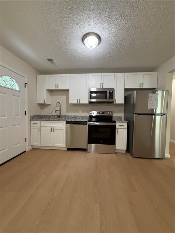 3319 Decatur Street Columbus, GA 31906 - Photo 3 of 18 a large kitchen with cabinets stainless steel appliances and a window