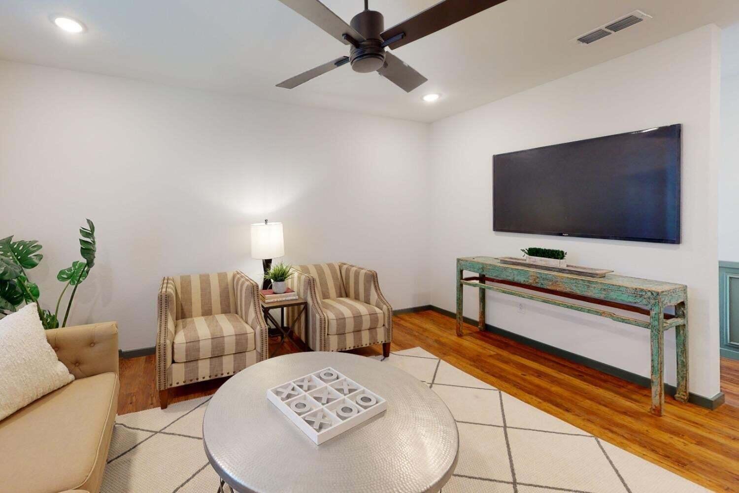 3617 128th Street Lubbock, TX 79423 - Photo 18 of 30 a living room with furniture and a flat screen tv