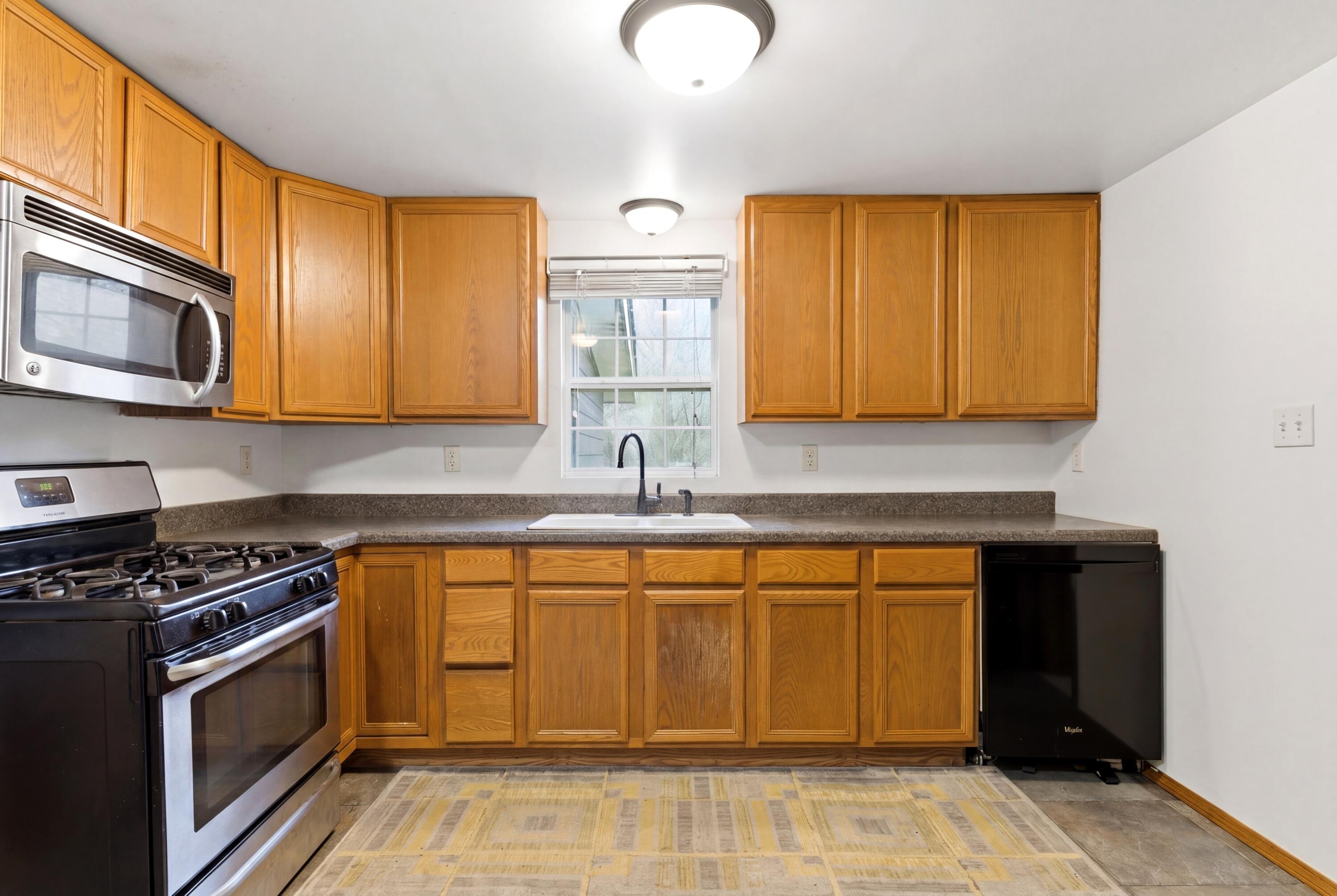 17333 North 700th Street West Hebron, IN 46341 - Photo 11 of 35 a kitchen with stainless steel appliances granite countertop a stove a sink and a microwave