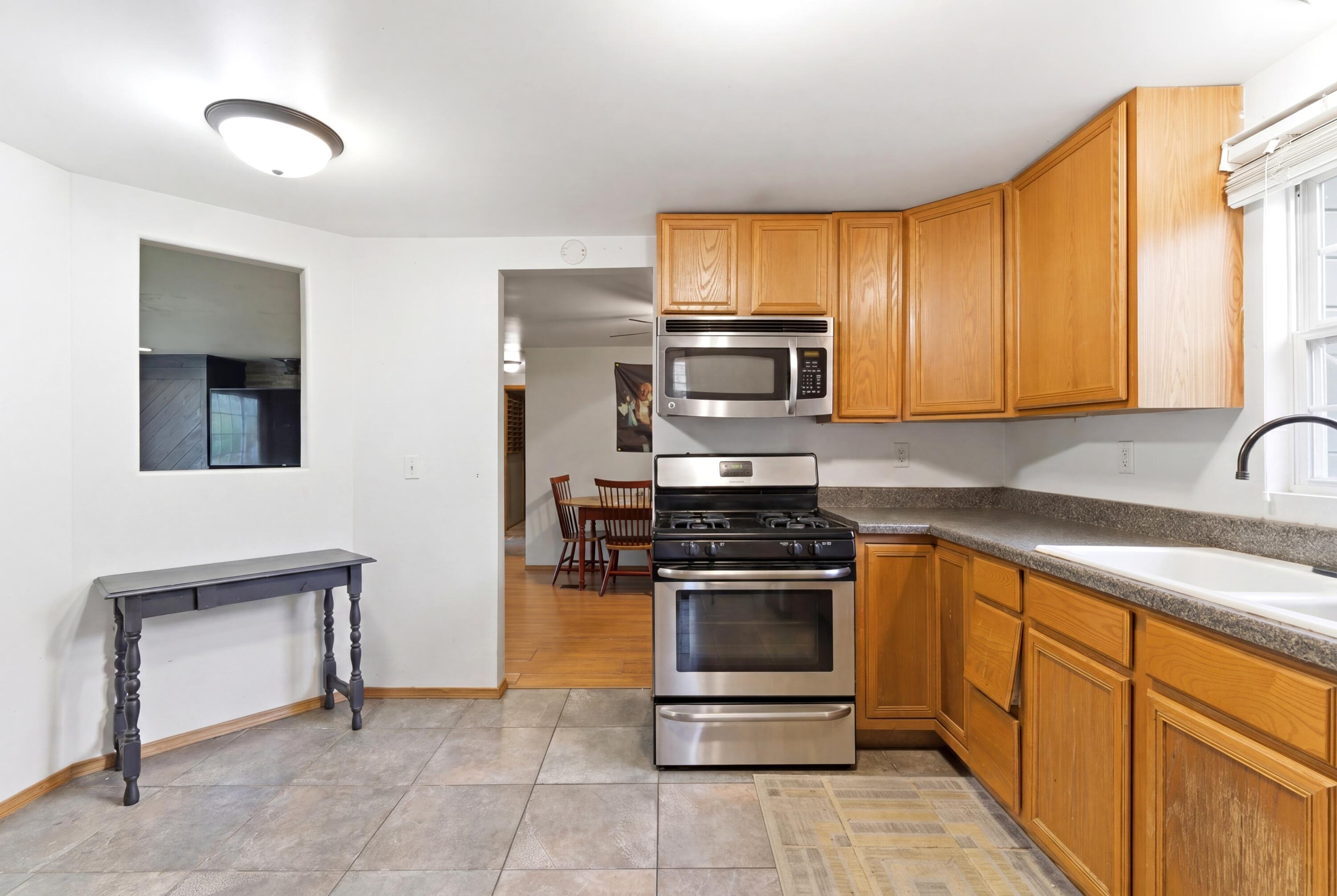 17333 North 700th Street West Hebron, IN 46341 - Photo 12 of 35 a kitchen with stainless steel appliances granite countertop a stove a sink and a microwave