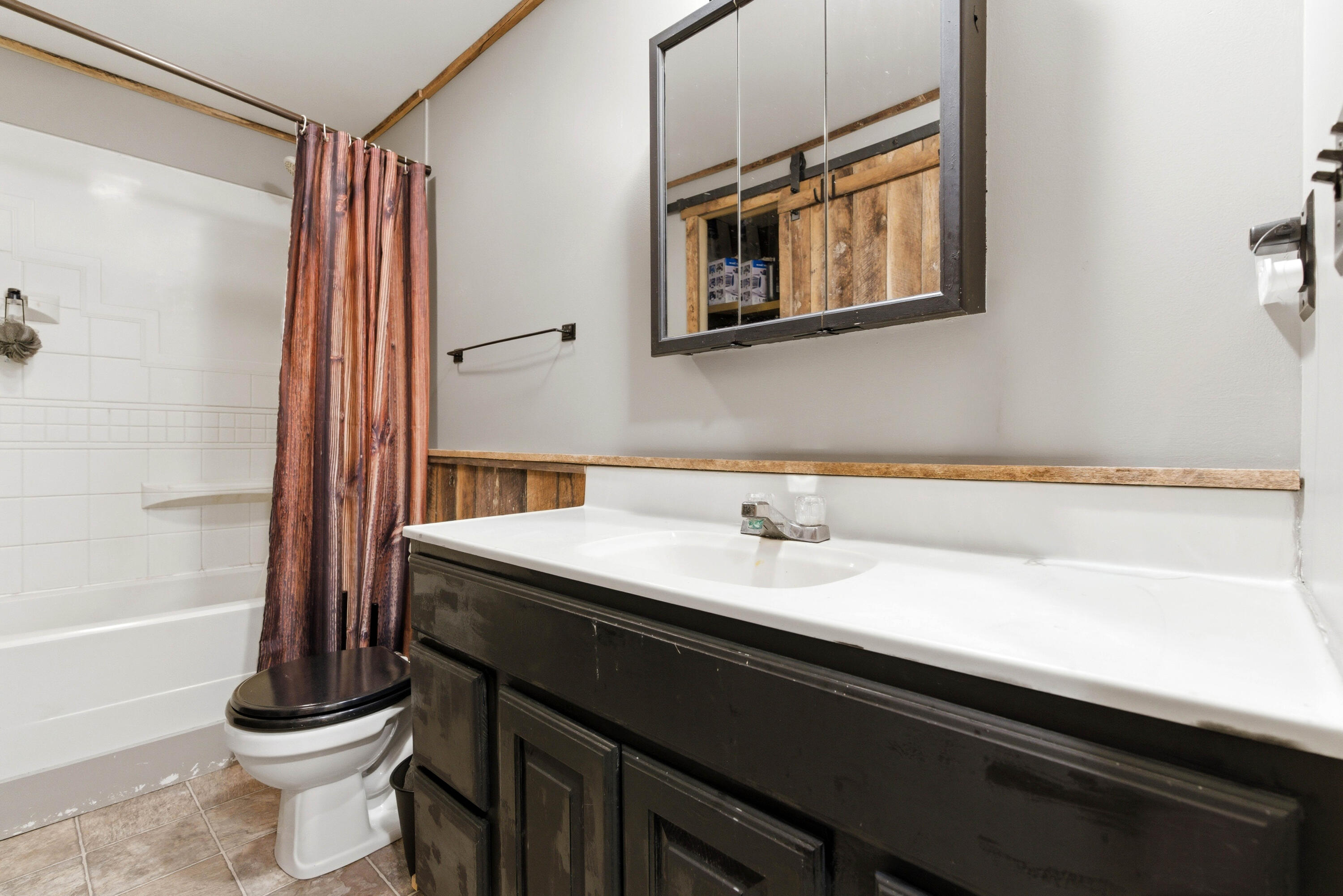 17333 North 700th Street West Hebron, IN 46341 - Photo 8 of 35 a bathroom with a sink a toilet and a mirror
