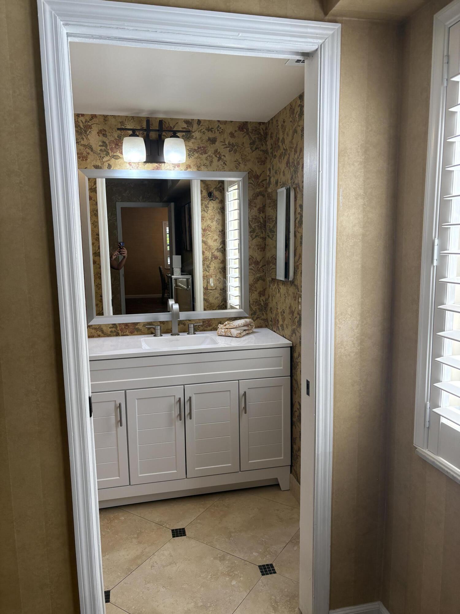 157 Capri East Delray Beach, FL 33484 - Photo 13 of 20 a bathroom with a sink and a mirror