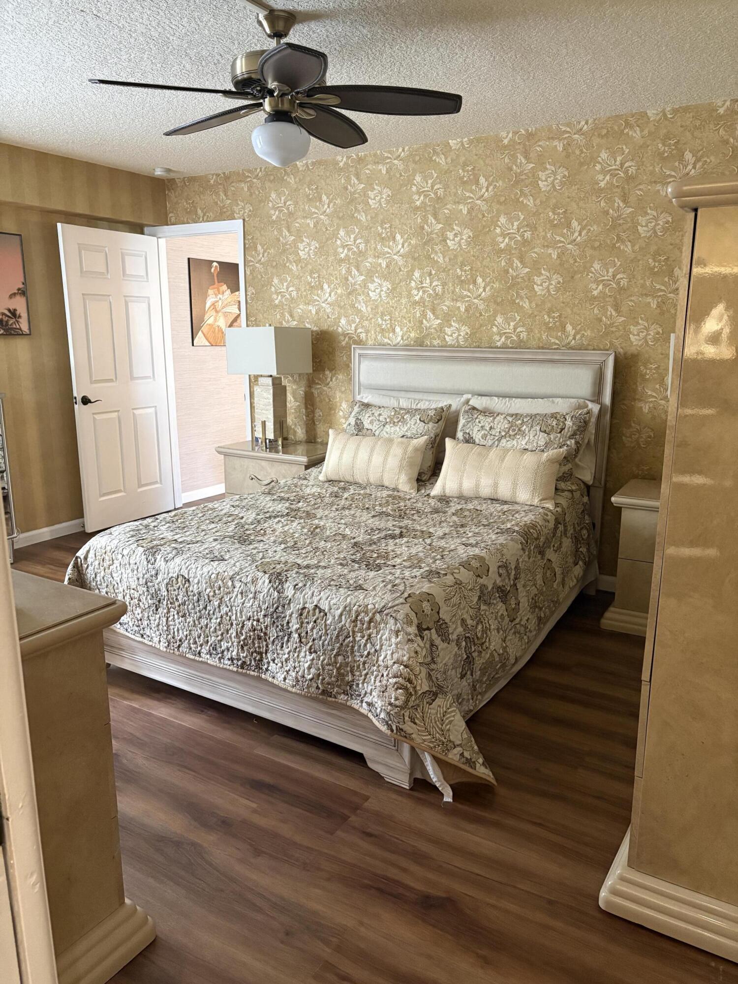 157 Capri East Delray Beach, FL 33484 - Photo 15 of 20 a bedroom with a bed and wooden floor