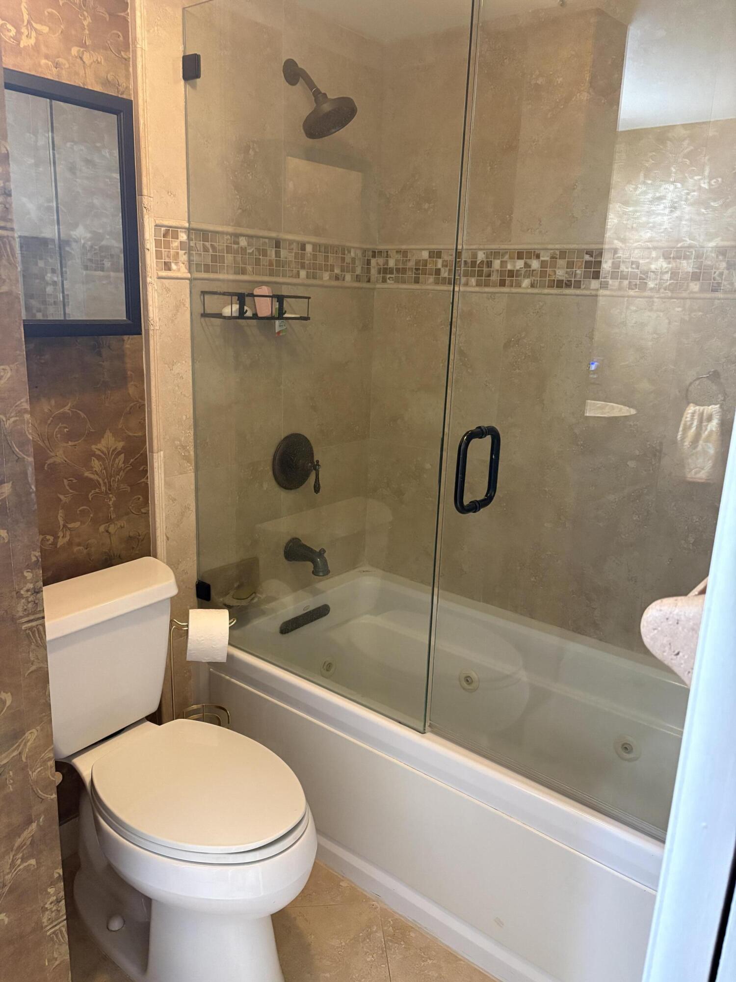 157 Capri East Delray Beach, FL 33484 - Photo 6 of 20 a bathroom with a toilet and a shower