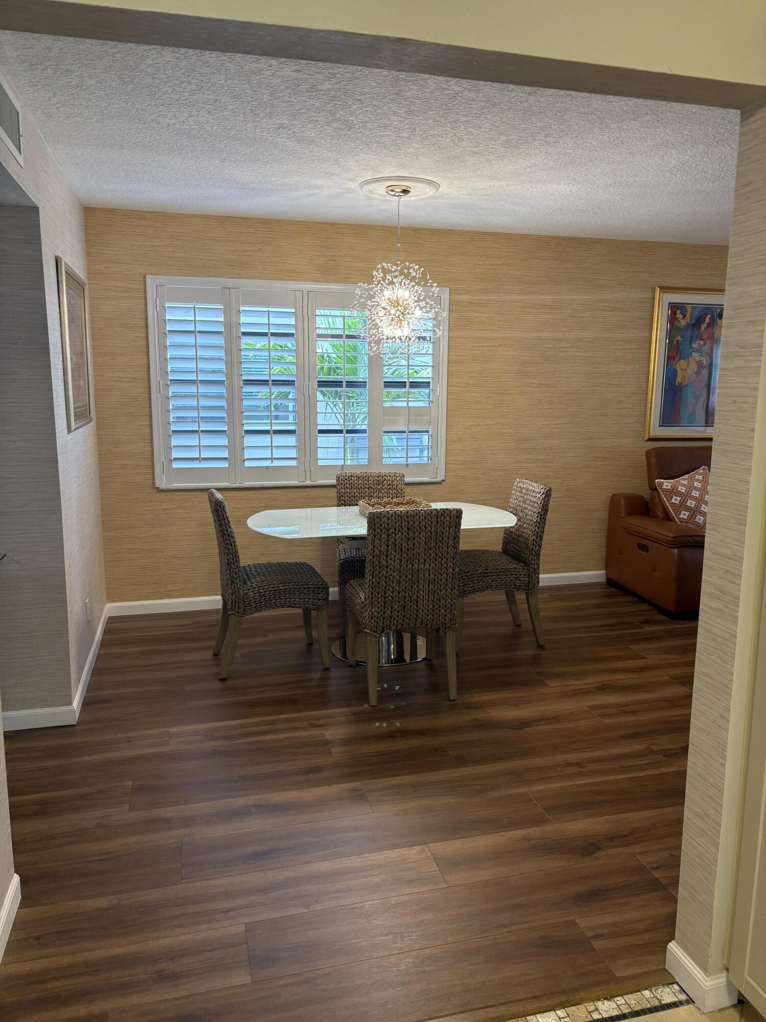 157 Capri East Delray Beach, FL 33484 - Photo 8 of 20 a view of a dining room with furniture and wooden floor