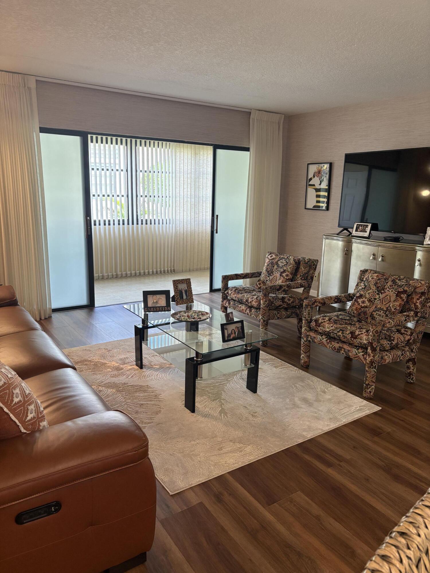 157 Capri East Delray Beach, FL 33484 - Photo 10 of 20 a living room with furniture and a flat screen tv