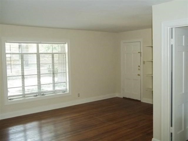 2511 Enfield Road, Unit A Austin, TX 78703 - Photo 3 of 5 an empty room with wooden floor and windows
