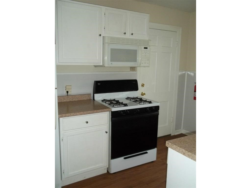 2511 Enfield Road, Unit A Austin, TX 78703 - Photo 4 of 5 a kitchen with granite countertop white cabinets and appliances