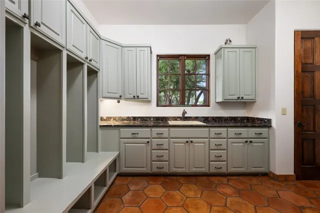 an aerial view of a house with swimming pool and a yard