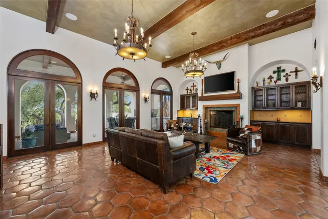 a kitchen with stainless steel appliances kitchen island granite countertop a table chairs in it and wooden floors